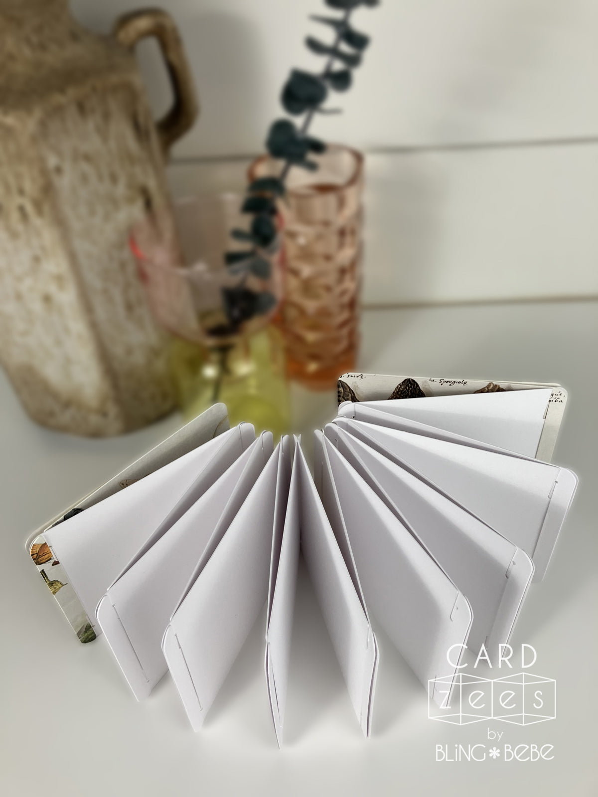 Display of CARDzees notebook, a scrapbook, a journal, a storybook, or a sketchbook. Paint, sketch, stamp or sticker, fold flat or expand to make an eye catching display. 